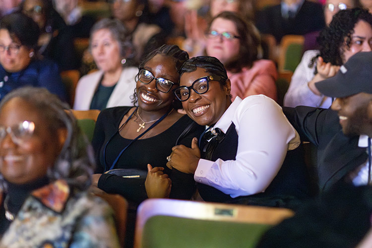 Two women in class hugging
